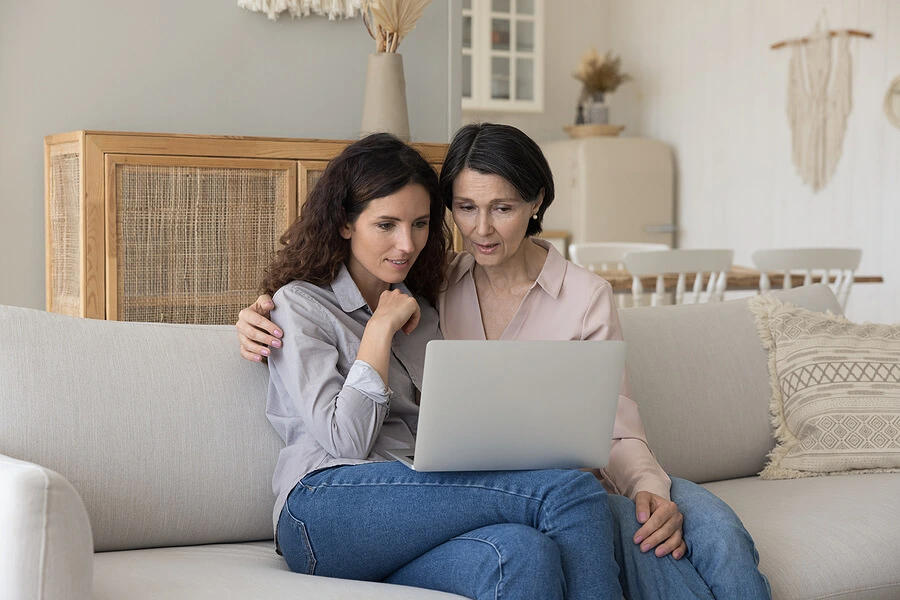 Daughter and Mother Looking At A Laptop Screen